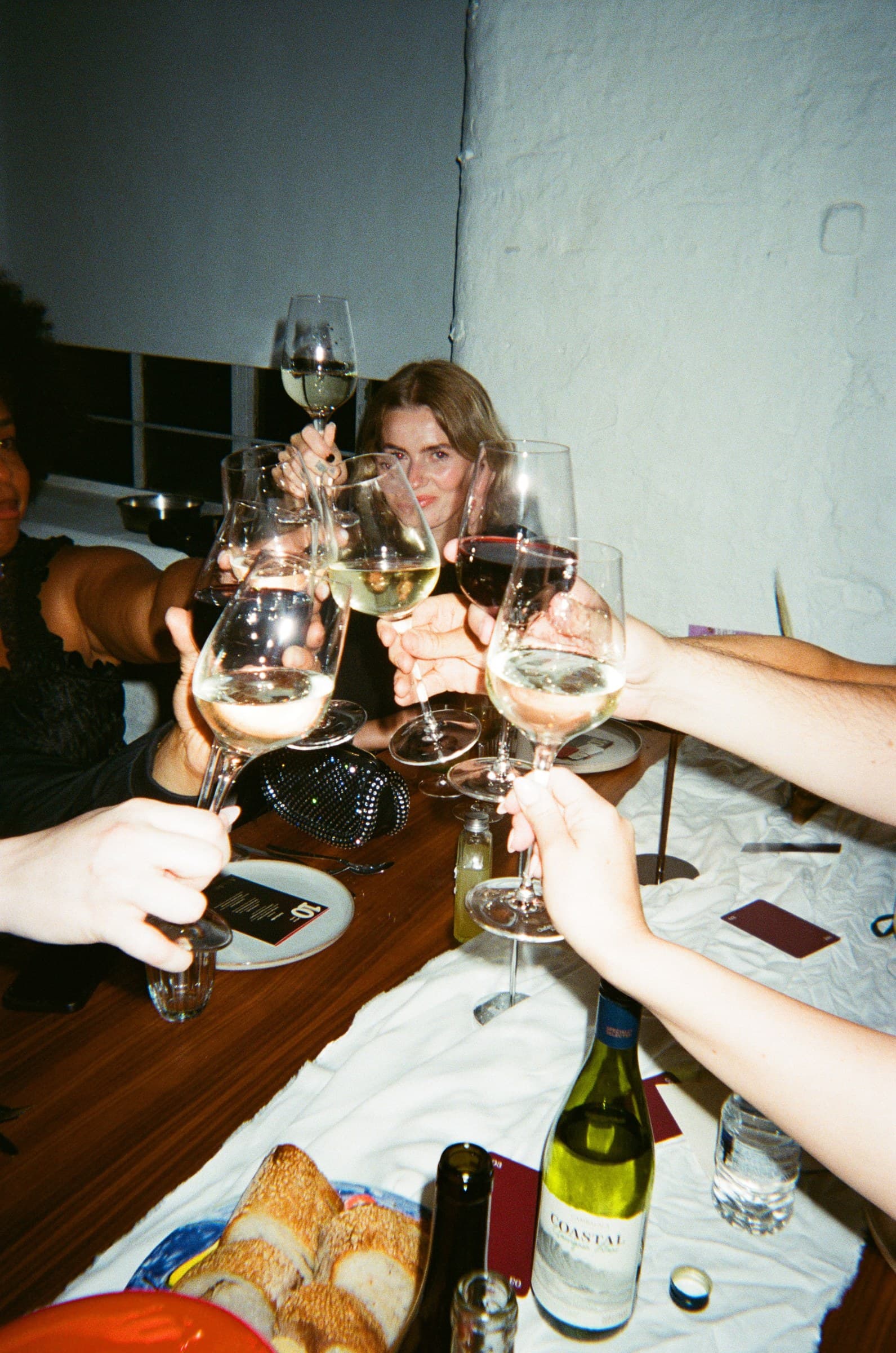 Guests raising glasses in a toast across the MCR 06 dinner table